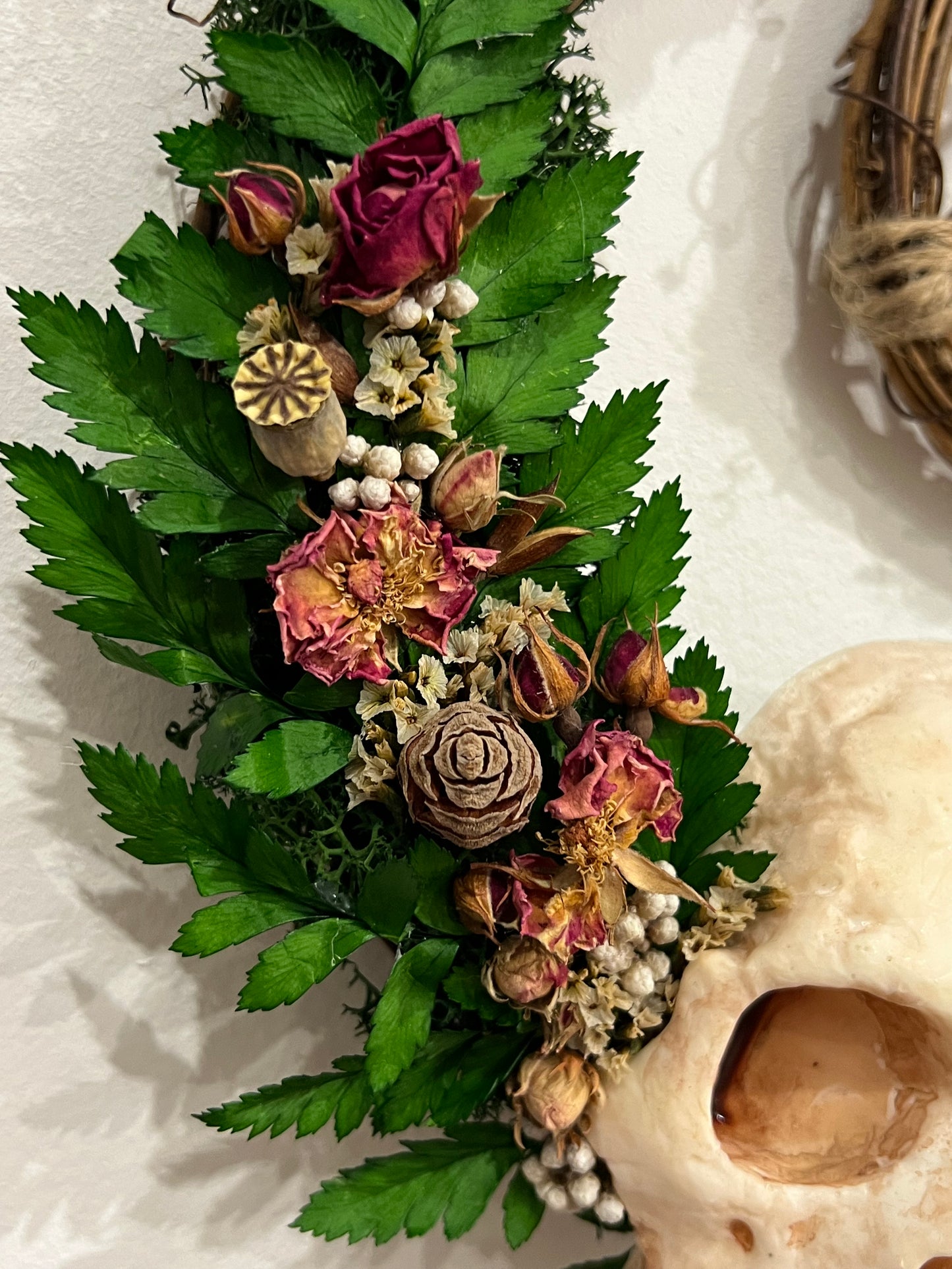 Kranz mit Harzschädel, Rosen und Samen